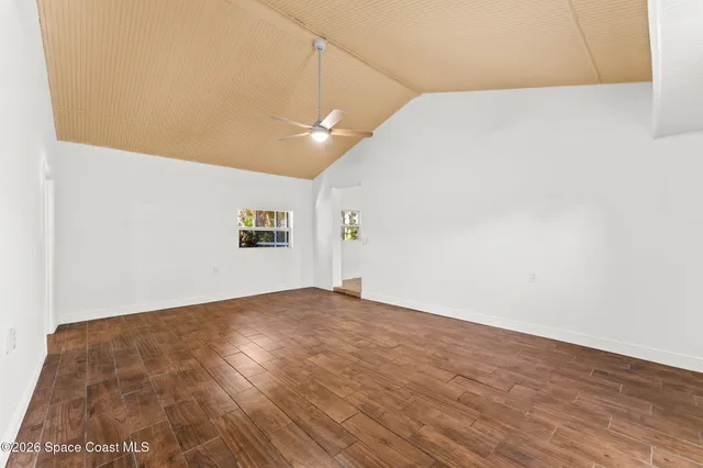 a bathroom with a granite countertop sink mirror vanity bathtub and a toilet