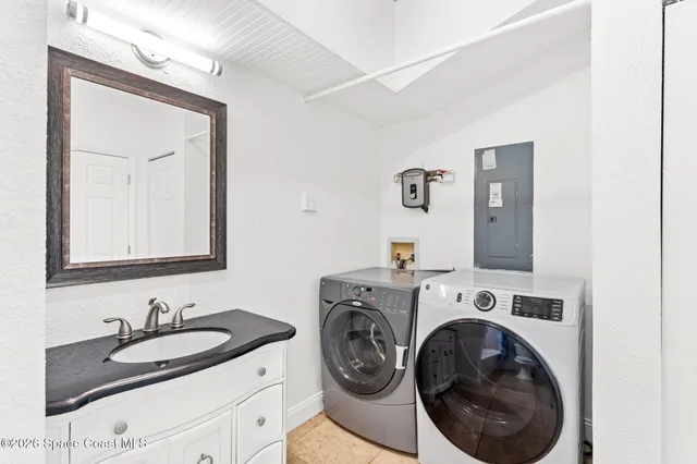 a kitchen with stainless steel appliances granite countertop a sink and a stove with wooden floor