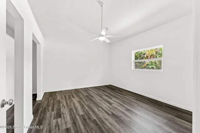 a view of a park with plants and trees beside of it