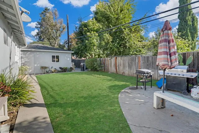 a backyard of a house with plants and trees