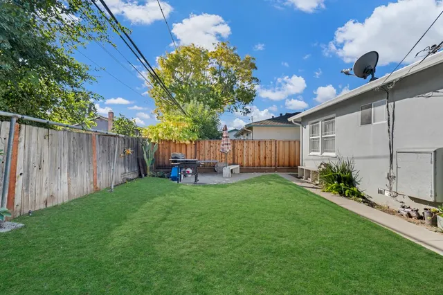 a backyard of a house with table and chairs
