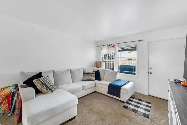 a kitchen that has a lot of cabinets a sink and appliances