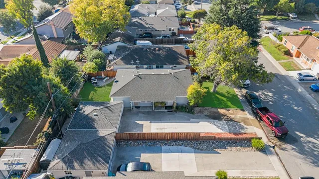 an aerial view of a house with a yard basket ball court and outdoor seating