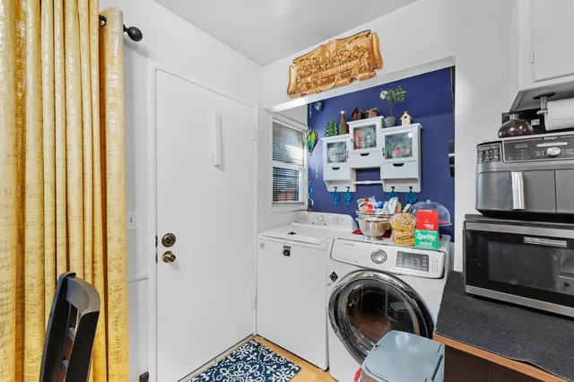 a kitchen with stainless steel appliances kitchen island granite countertop a refrigerator and a sink