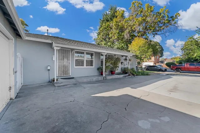 a view of house with backyard and a garden