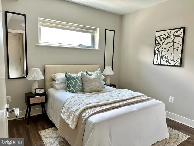 a bedroom with a bed and a painting on the wall