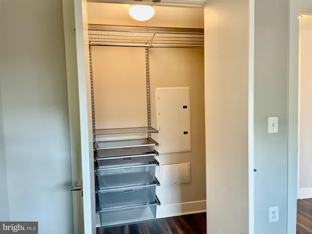 a view of walk in closet with empty racks