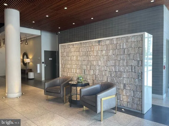 a view of a livingroom with furniture and a hallway