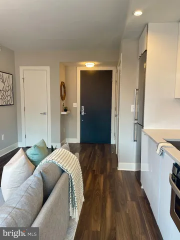 a bedroom with bed and wooden floor