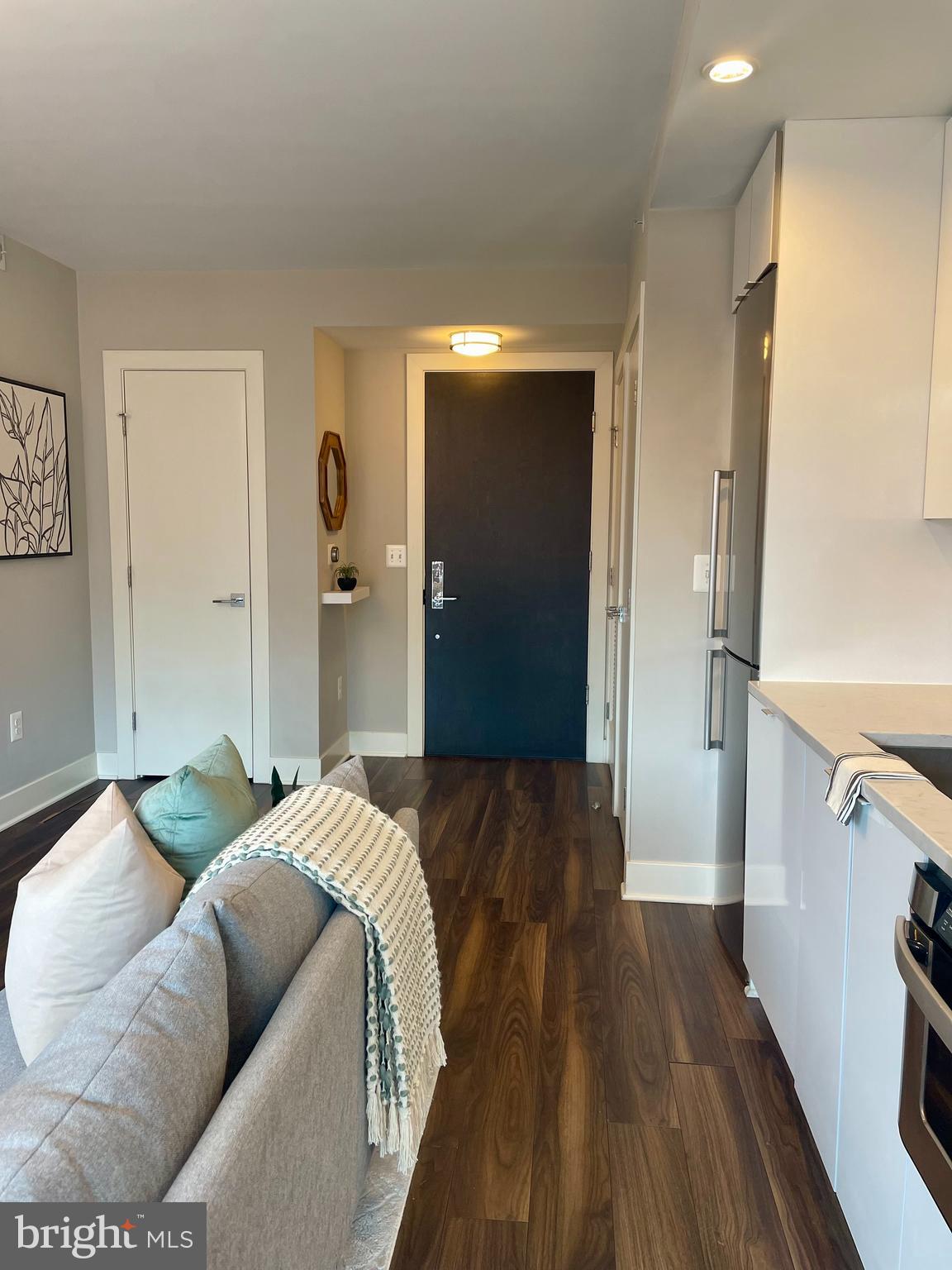 1311 13th Street Northwest, Unit 308 Washington, DC 20005 - Photo 3 of 22 a bedroom with bed and wooden floor