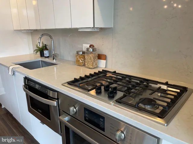 a stove top oven sitting inside of a kitchen