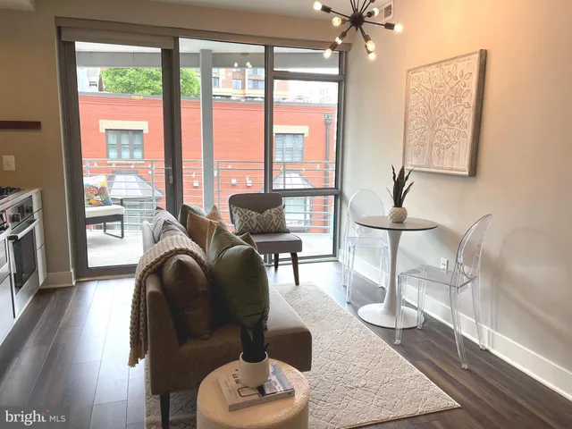 a living room with furniture and a floor to ceiling window