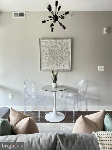 a living room with furniture and a chandelier