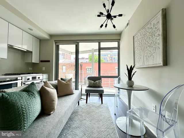 a living room with furniture and floor to ceiling windows