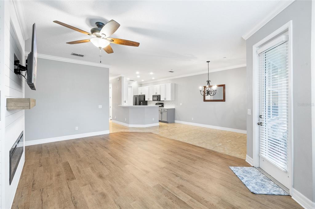 7467 Terrace River Drive Temple Terrace, FL 33637 - Photo 17 of 46 a view of a livingroom with a ceiling fan and wooden floor