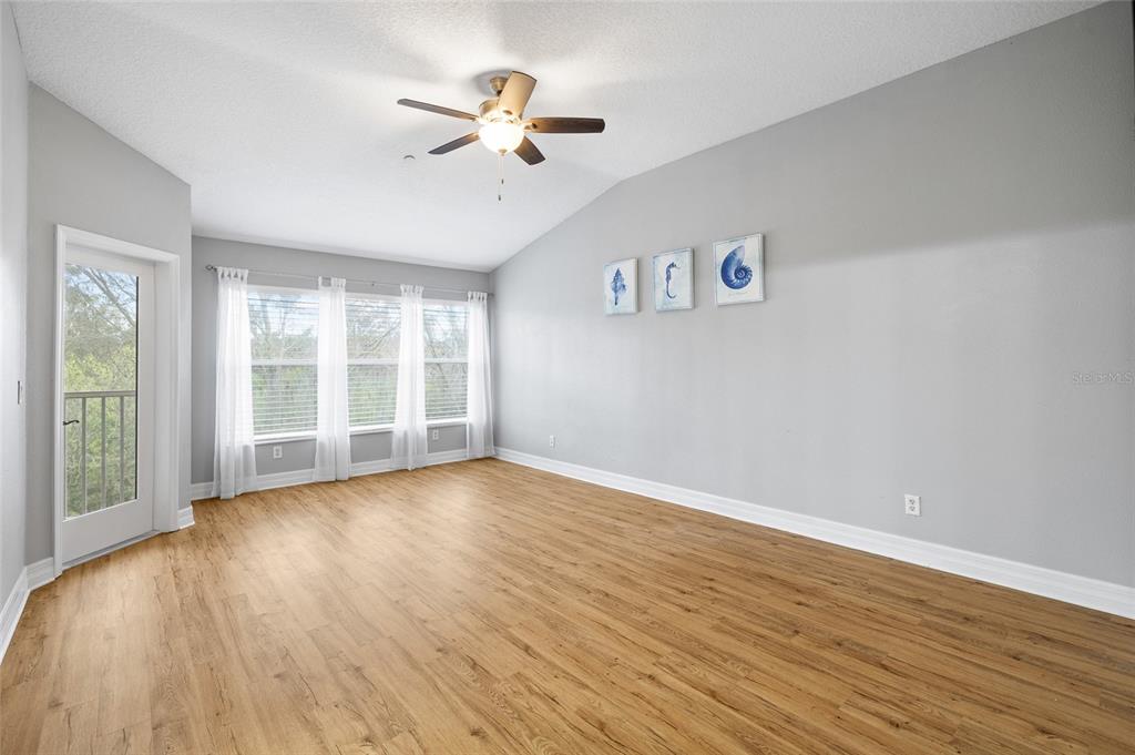7467 Terrace River Drive Temple Terrace, FL 33637 - Photo 19 of 46 wooden floor in an empty room with a window