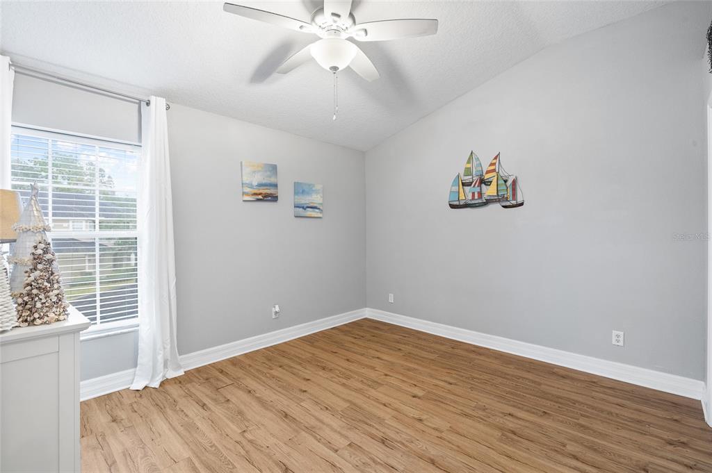 7467 Terrace River Drive Temple Terrace, FL 33637 - Photo 29 of 46 a view of an empty room with a window and wooden floor