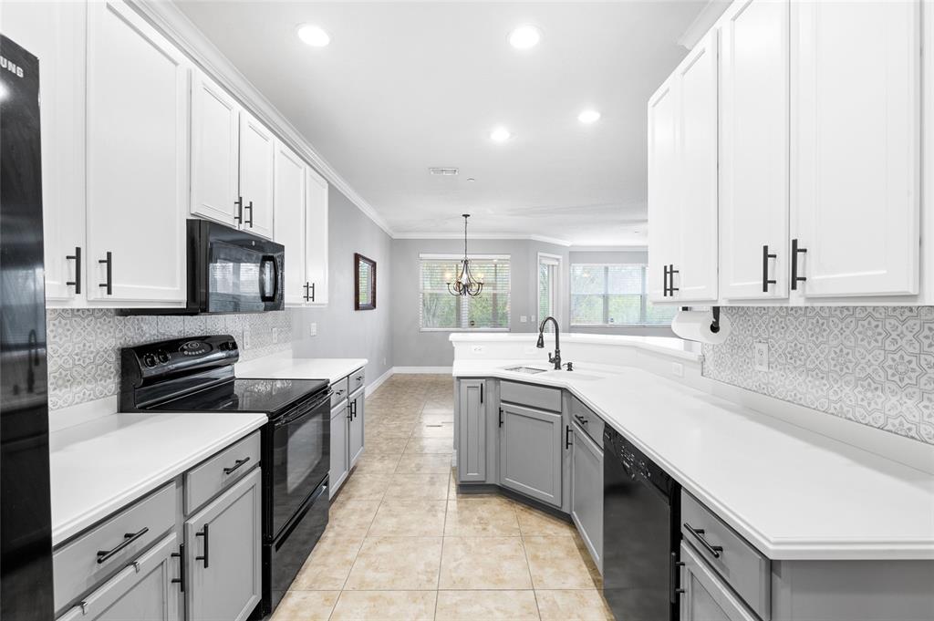 7467 Terrace River Drive Temple Terrace, FL 33637 - Photo 6 of 46 a kitchen with stainless steel appliances a sink stove and cabinets