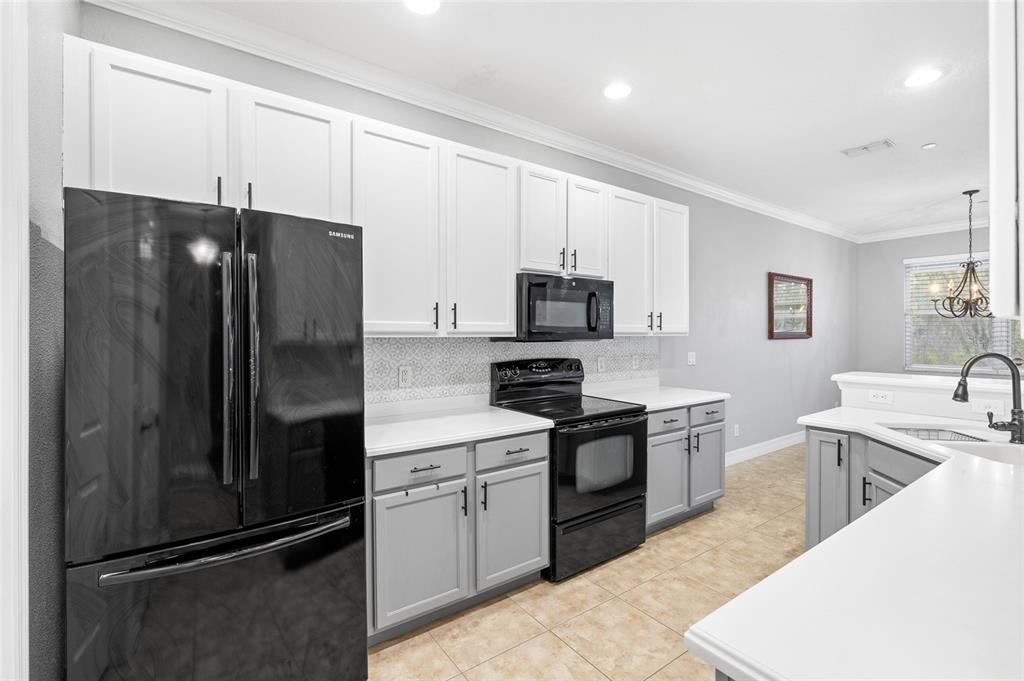 7467 Terrace River Drive Temple Terrace, FL 33637 - Photo 8 of 46 a kitchen with stainless steel appliances granite countertop a refrigerator sink and stove