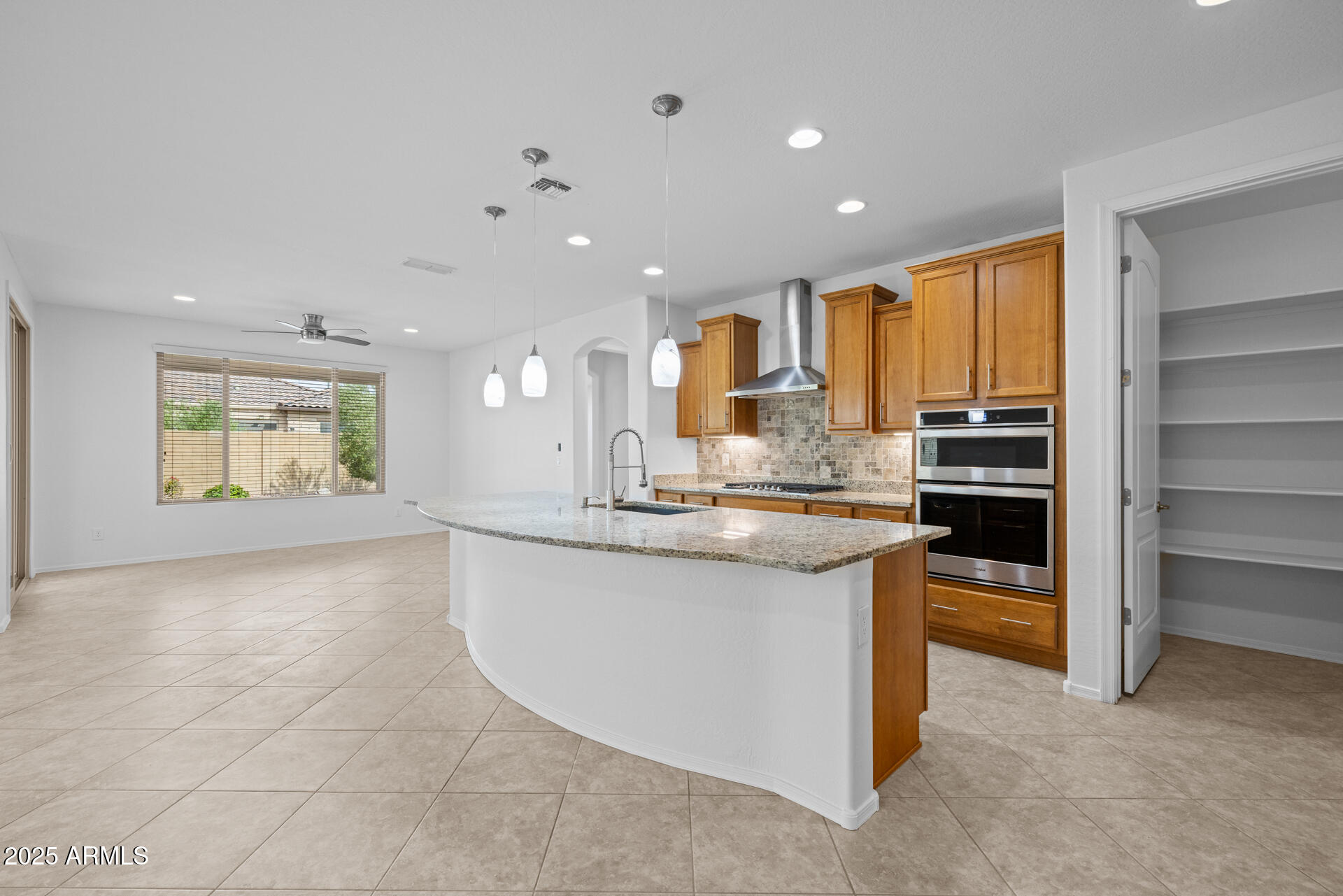 8160 West Cinder Brook Way Florence, AZ 85132 - Photo 14 of 81 a kitchen with stainless steel appliances granite countertop a stove and a sink