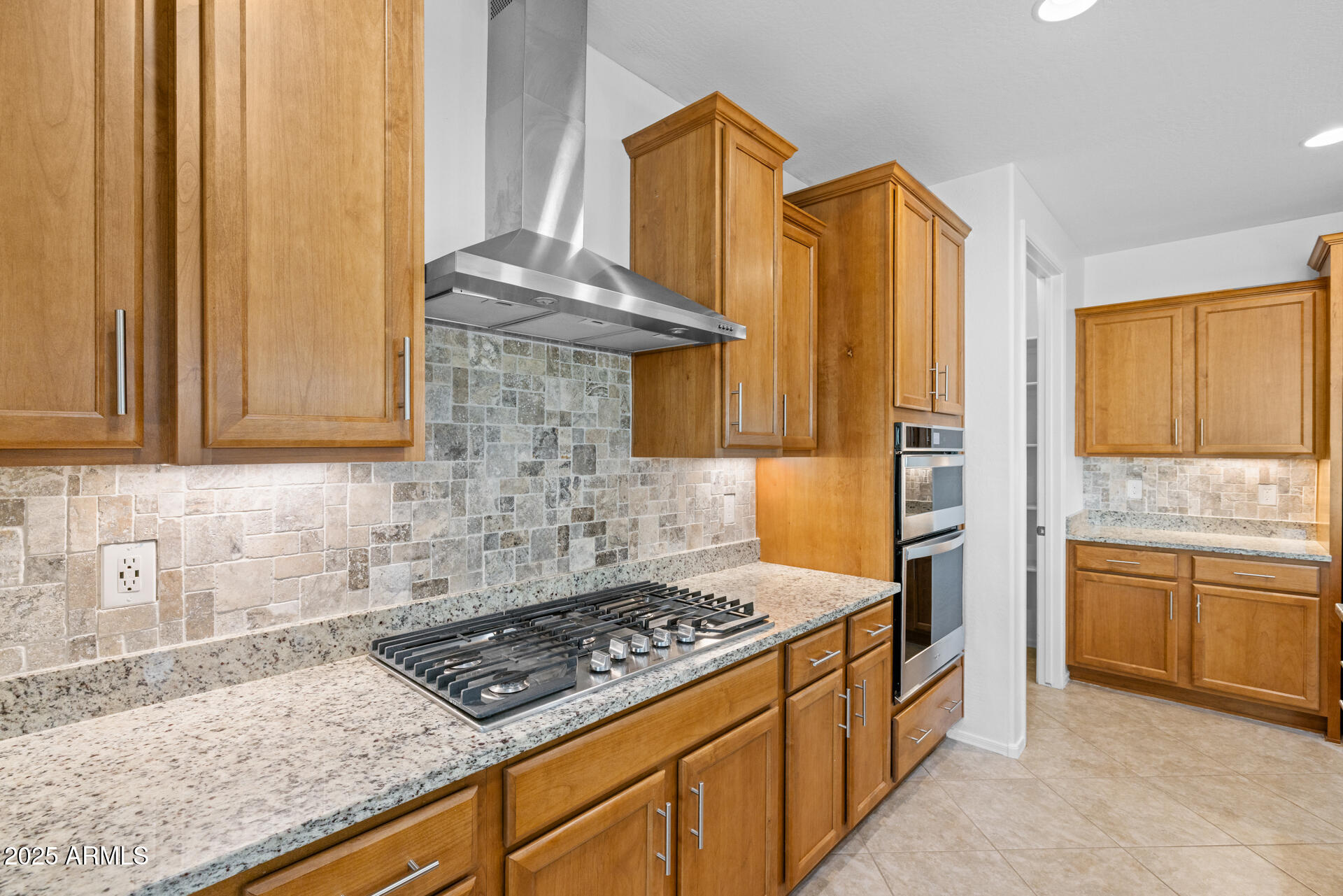 8160 West Cinder Brook Way Florence, AZ 85132 - Photo 15 of 81 a kitchen with stainless steel appliances granite countertop a stove a sink and a microwave