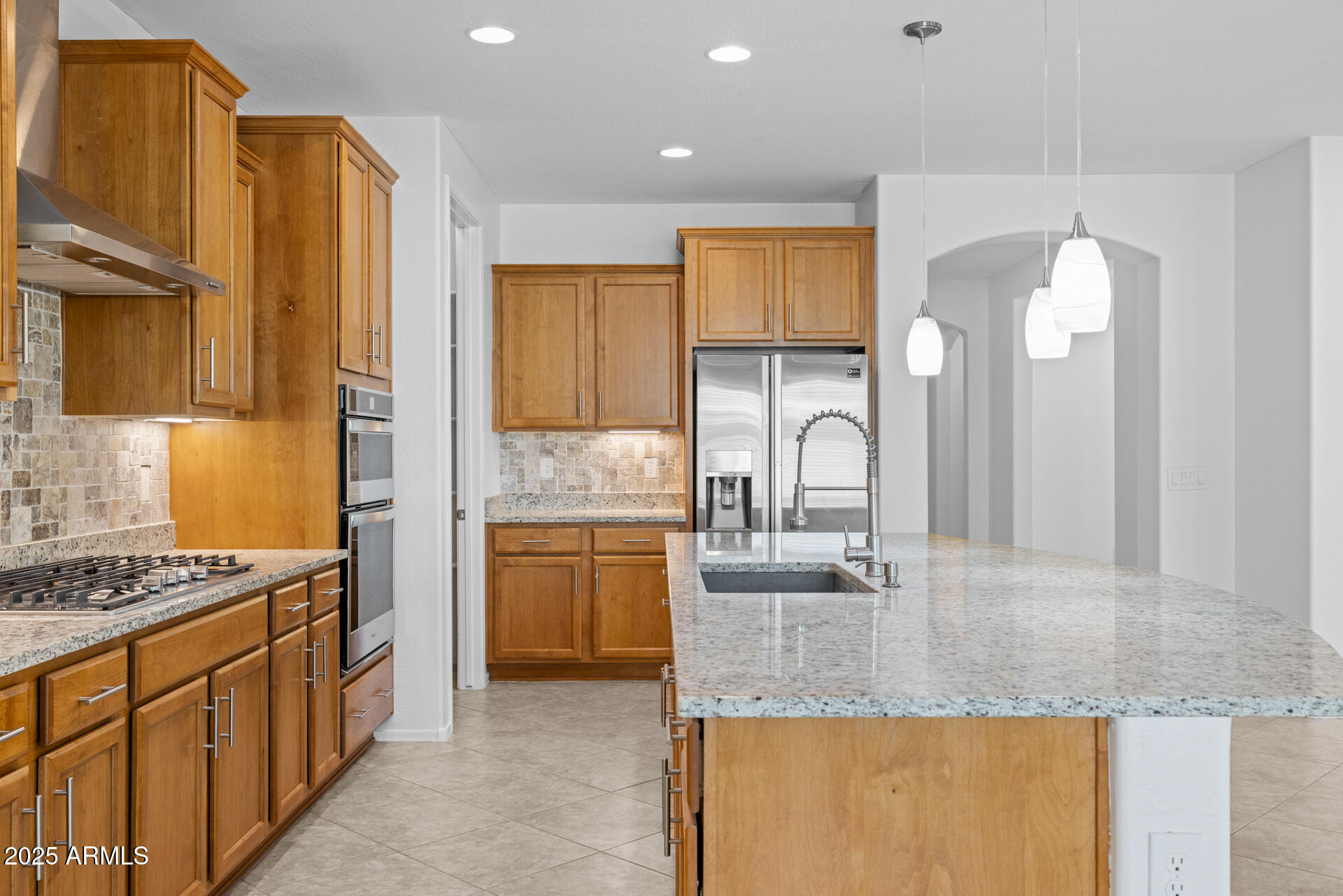 8160 West Cinder Brook Way Florence, AZ 85132 - Photo 16 of 81 a kitchen with granite countertop a sink a counter top space and stainless steel appliances