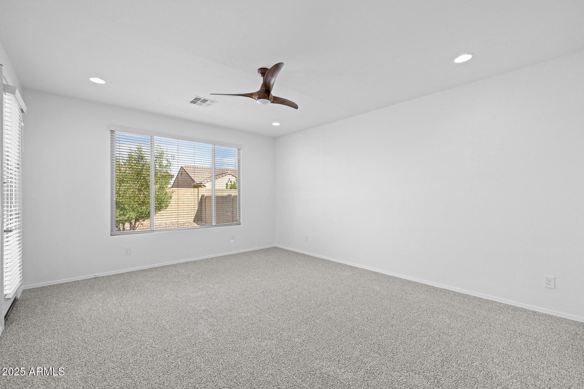 8160 West Cinder Brook Way Florence, AZ 85132 - Photo 19 of 81 an empty room with windows and ceiling fan