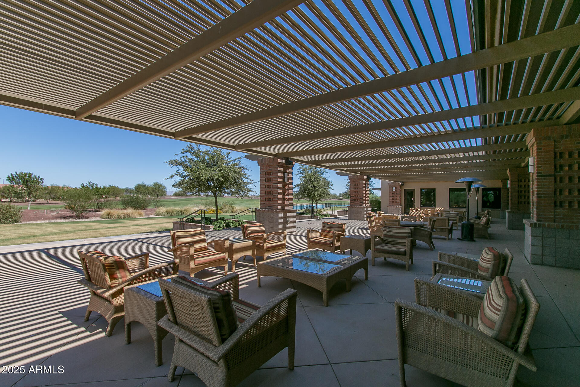 8160 West Cinder Brook Way Florence, AZ 85132 - Photo 75 of 81 a view of a patio with couches chairs dining table and chairs with wooden floor