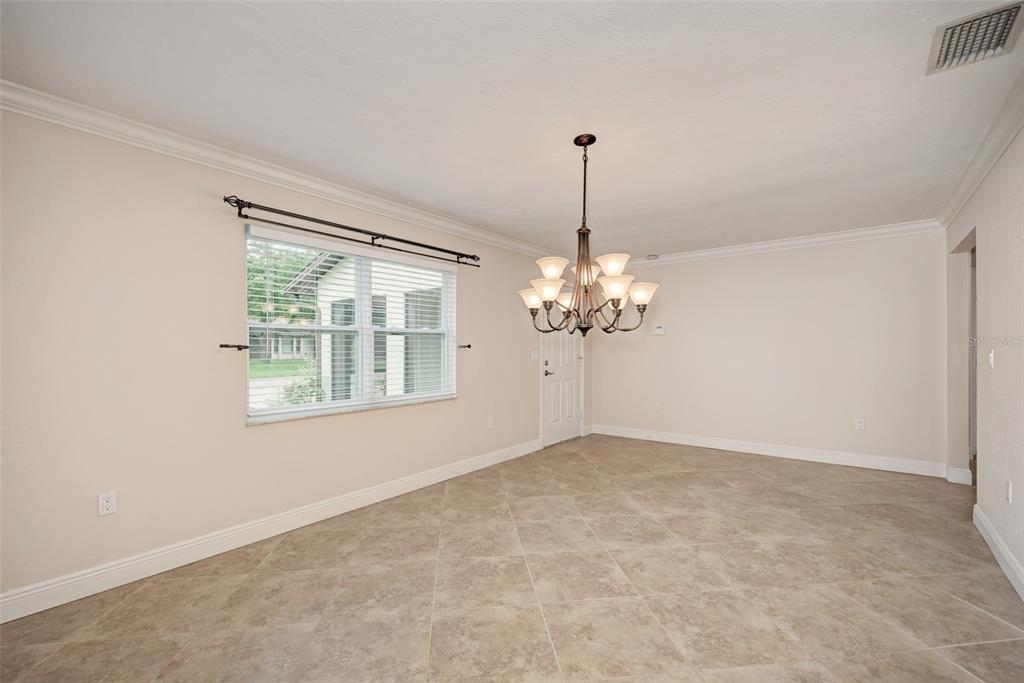 1330 Georgetowne Circle Sarasota, FL 34232 - Photo 7 of 46 a view of wooden floor chandelier and windows in a room