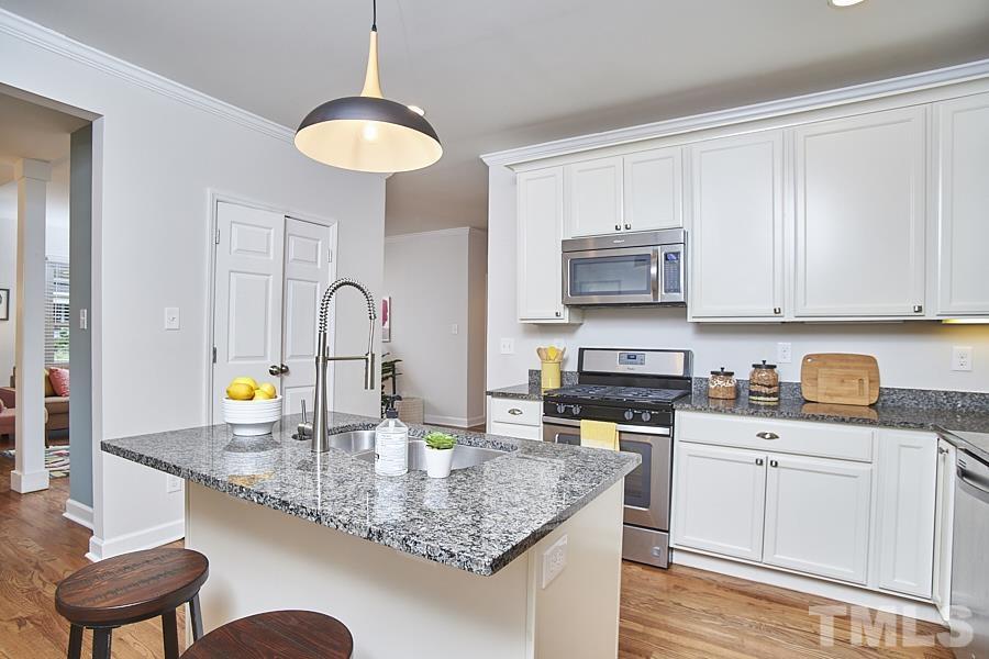 2203 Chapel Hill Road Durham, NC 27707 - Photo 16 of 37 a kitchen with stainless steel appliances granite countertop a stove a sink and a microwave