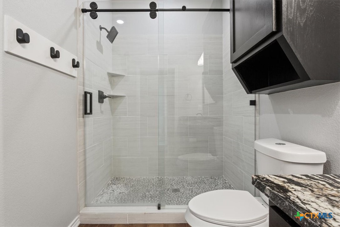 10940 Wedel Cemetery Road Rogers, TX 76569 - Photo 44 of 48 a bathroom with a toilet and a shower