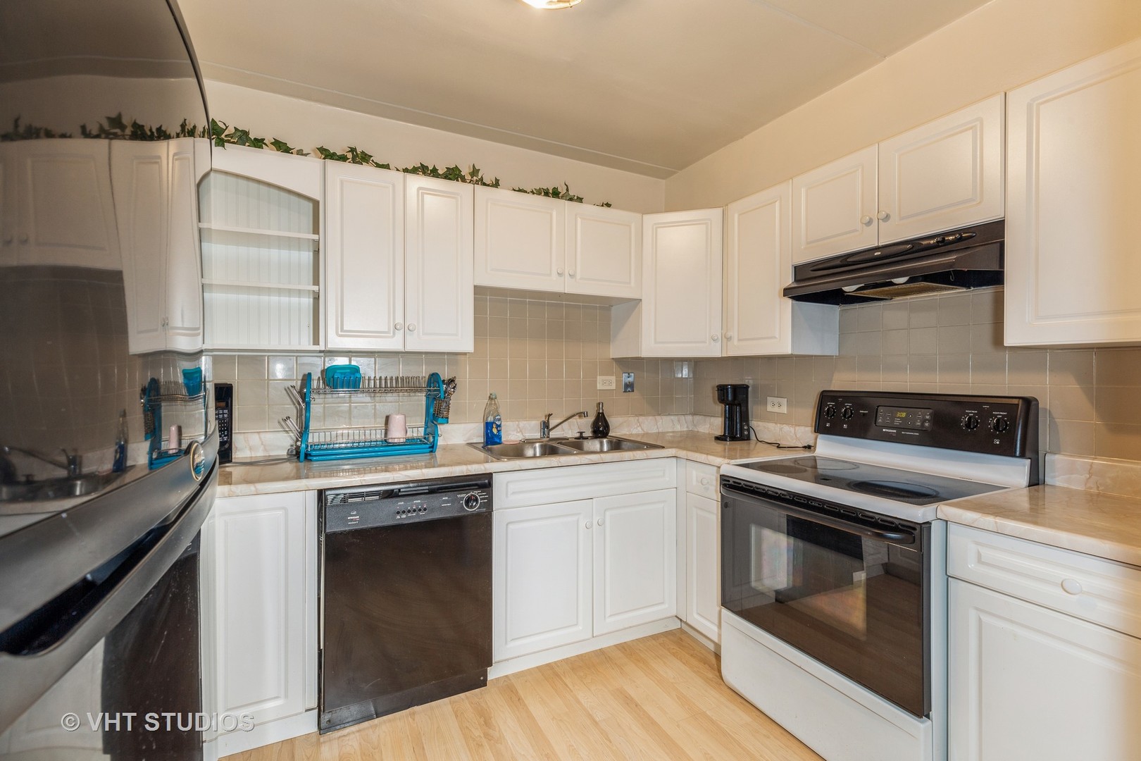 17001 Albany Avenue, Unit 101 Hazel Crest, IL 60429 - Photo 5 of 10 a kitchen with a stove top oven sink and cabinets