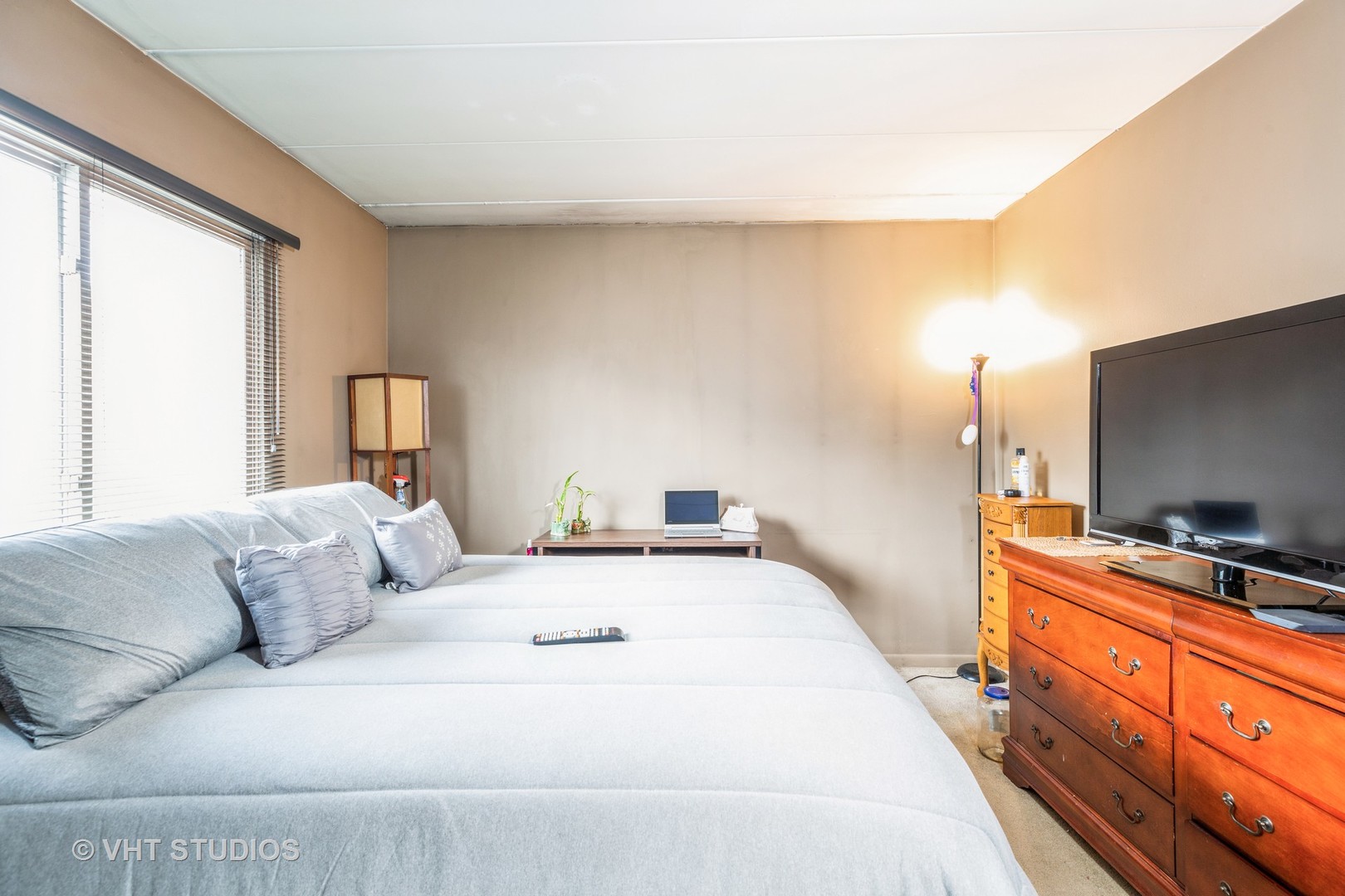 17001 Albany Avenue, Unit 101 Hazel Crest, IL 60429 - Photo 8 of 10 a bedroom with a bed and flat screen tv