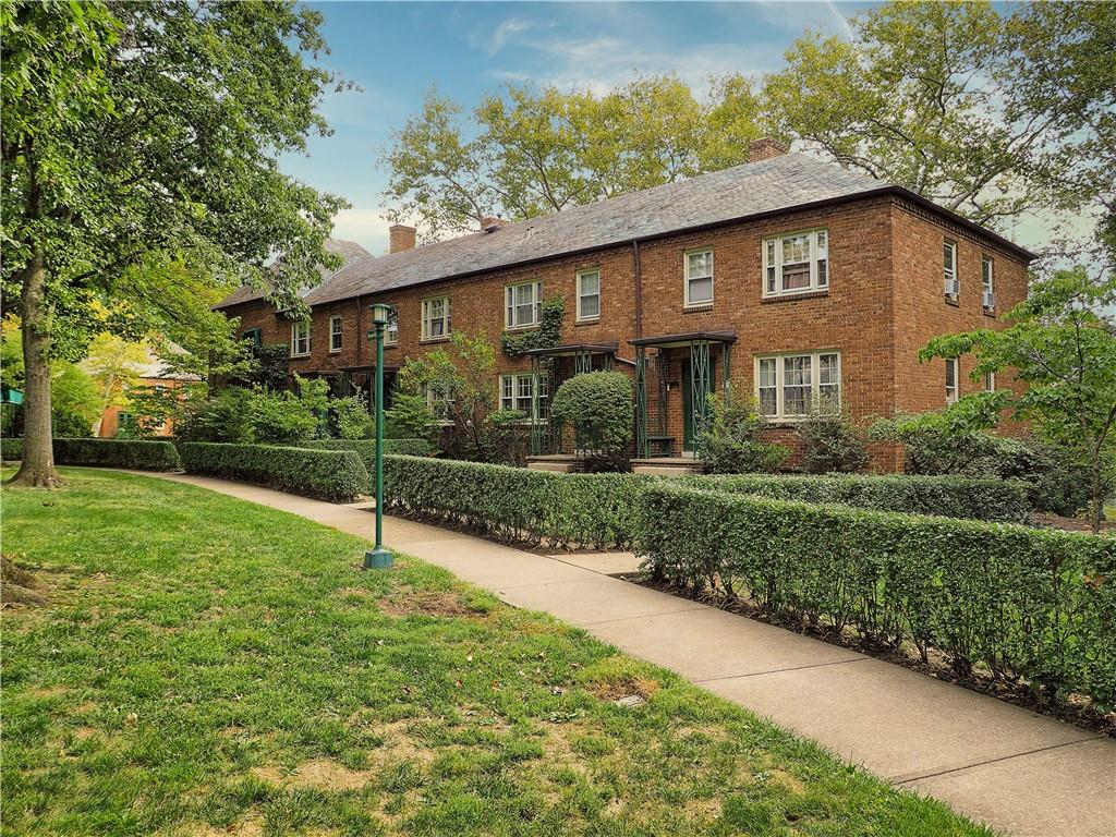 a front view of house with yard and green space