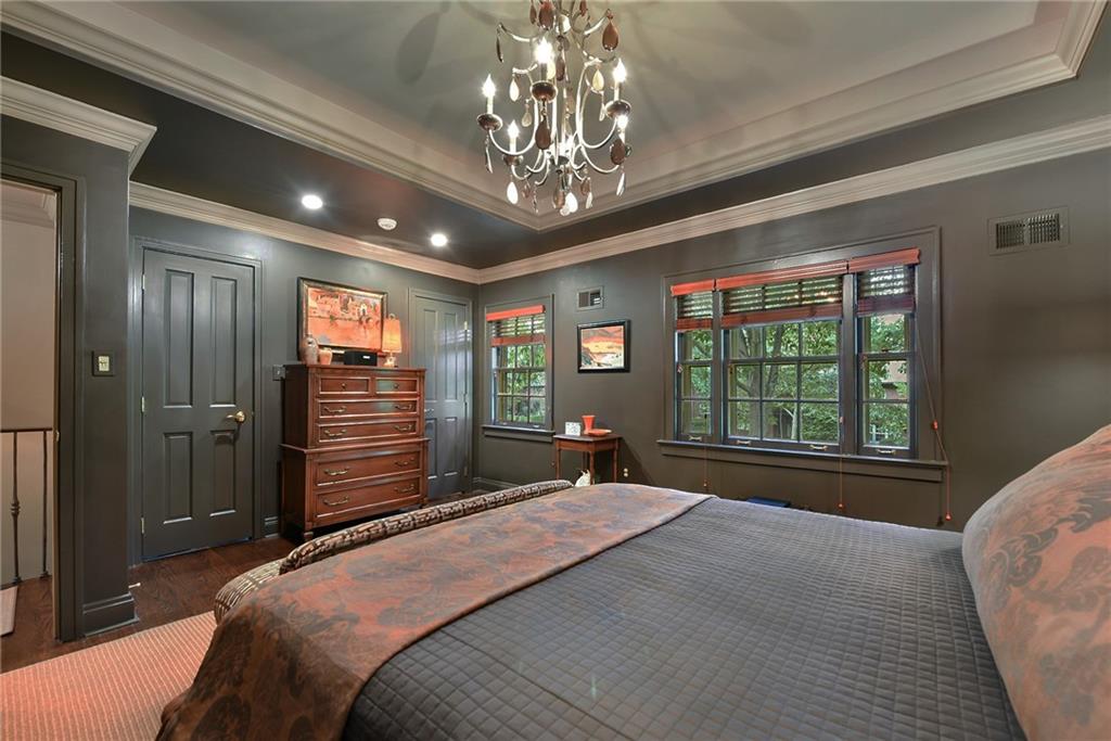 604 Pennridge Road Pittsburgh, PA 15211 - Photo 14 of 25 a spacious bedroom with a large bed and a chandelier