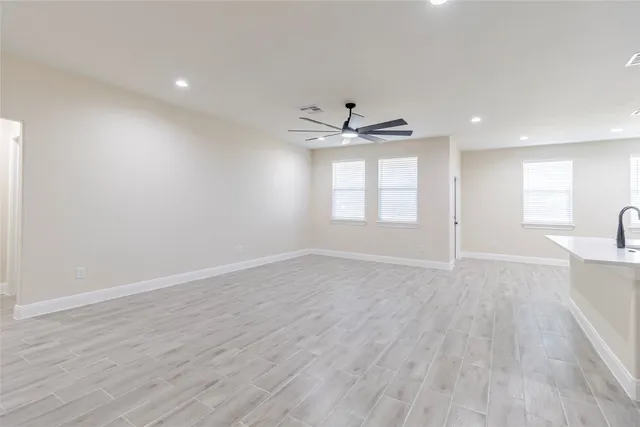 a open kitchen with kitchen island a sink dishwasher a stove and a refrigerator with wooden floor