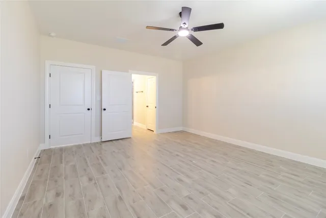 a spacious bathroom with a double vanity sink a mirror and a shower