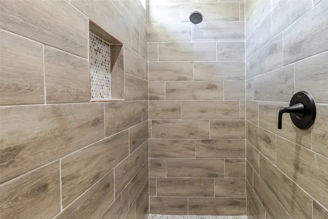 a view of an empty room with wooden floor and closet