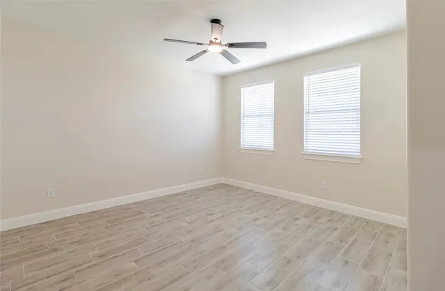 wooden floor in an empty room with a window