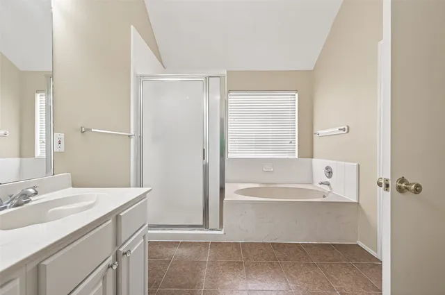 a bathroom with a bathtub and a sink