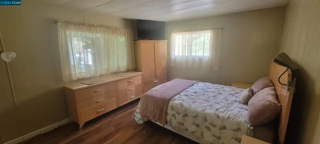 a bedroom with a bed and a closet with mirror