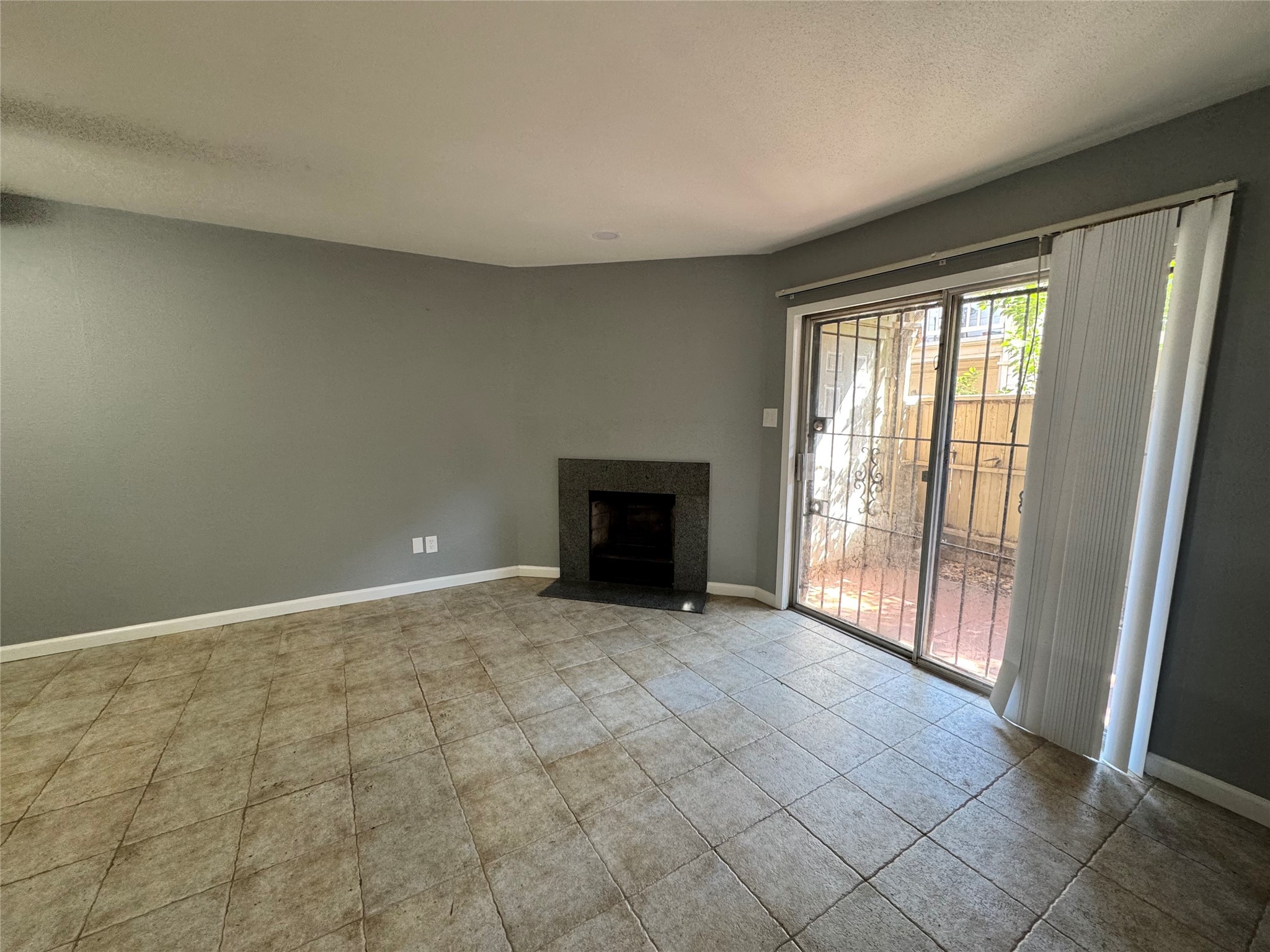 6001 Reims Road, Unit 309 Houston, TX 77036 - Photo 12 of 23 a view of an empty room with a fireplace and a window