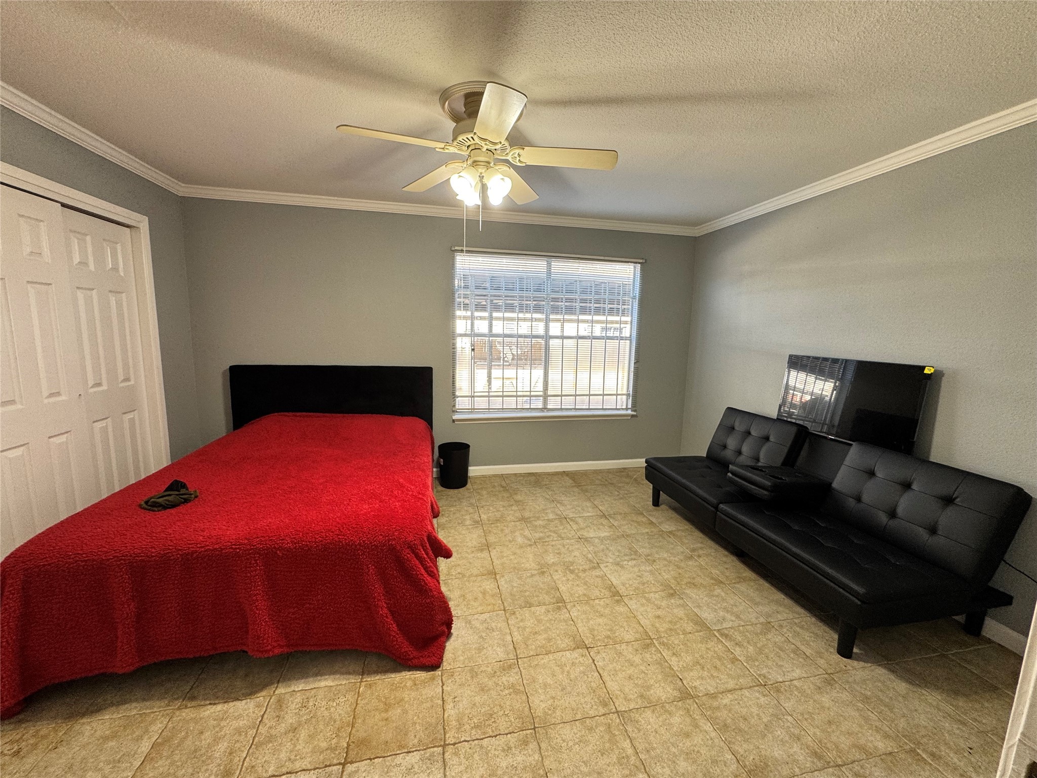 6001 Reims Road, Unit 309 Houston, TX 77036 - Photo 14 of 23 a bedroom with a bed and a couch