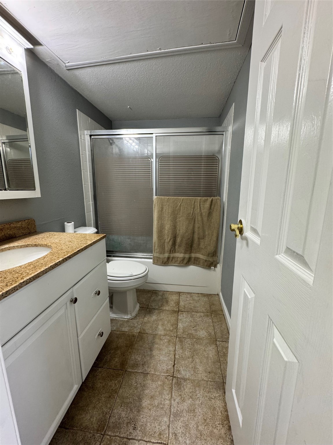6001 Reims Road, Unit 309 Houston, TX 77036 - Photo 18 of 23 a bathroom with a granite countertop sink toilet and shower