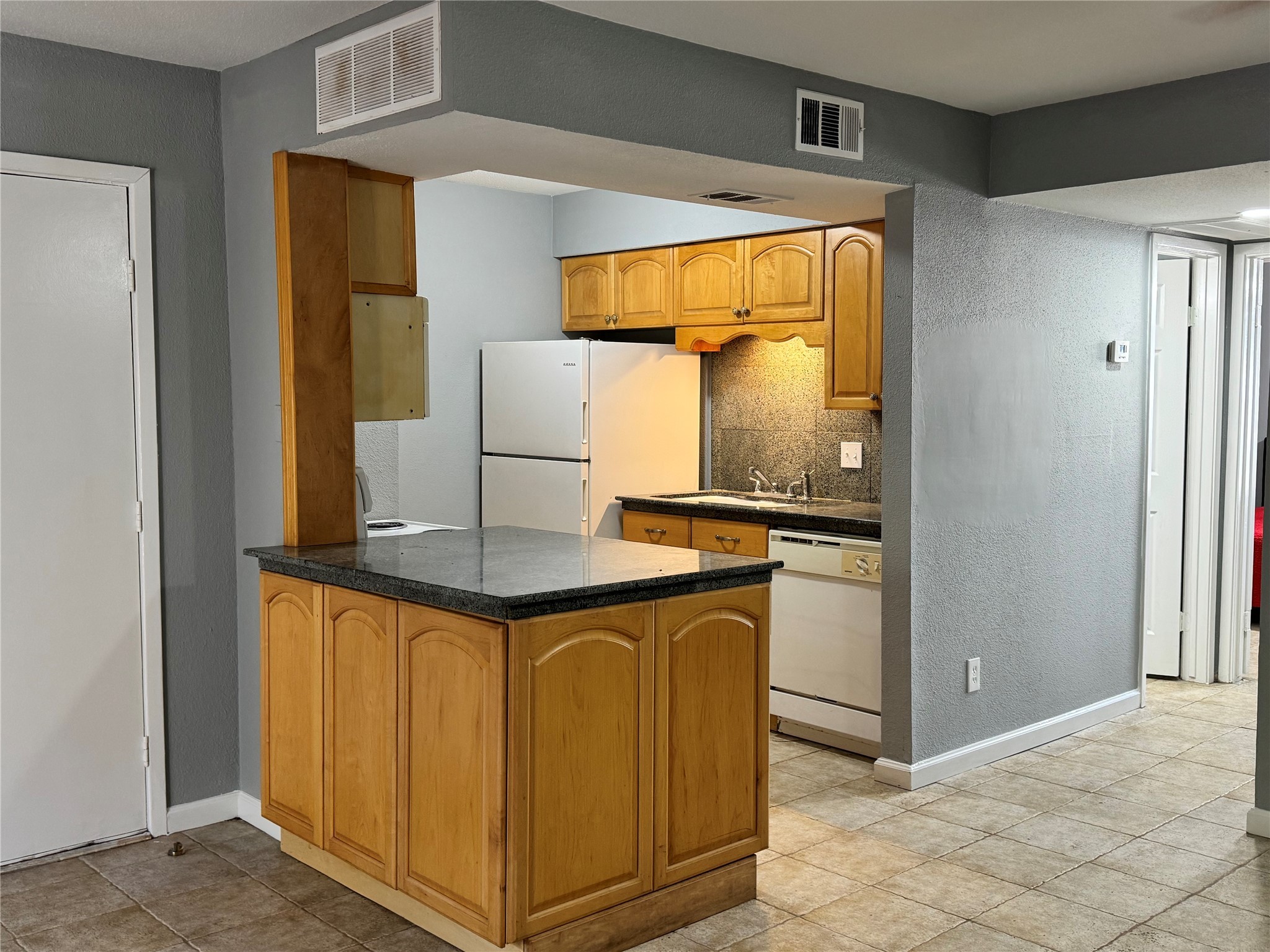 6001 Reims Road, Unit 309 Houston, TX 77036 - Photo 3 of 23 a kitchen with stainless steel appliances granite countertop a refrigerator and a stove