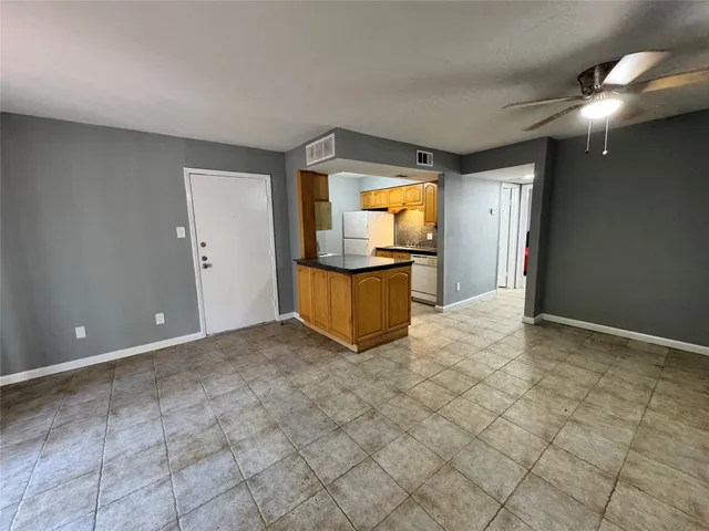 a view of a livingroom with wooden floor and a flat screen tv