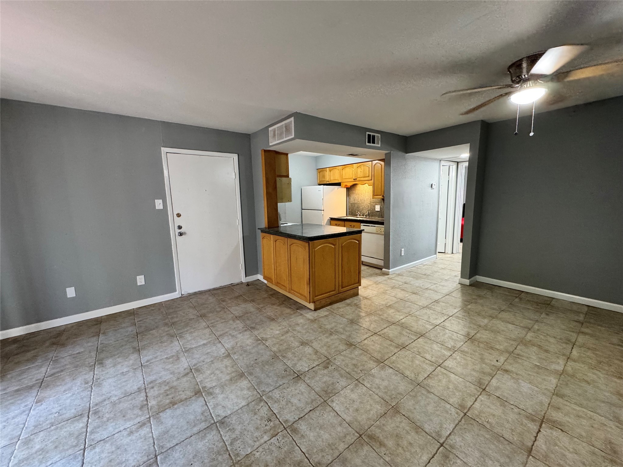 6001 Reims Road, Unit 309 Houston, TX 77036 - Photo 4 of 23 a view of a livingroom with wooden floor and a flat screen tv