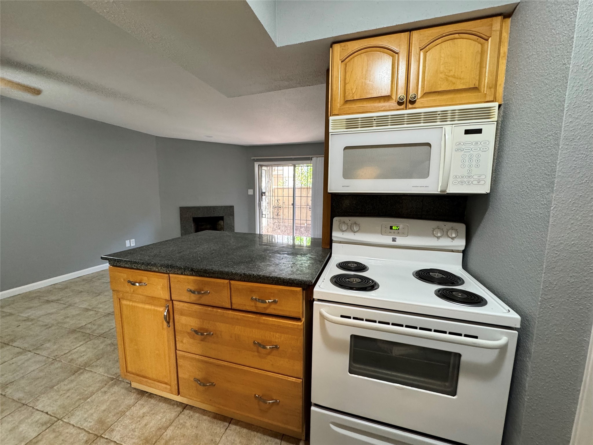 6001 Reims Road, Unit 309 Houston, TX 77036 - Photo 8 of 23 a kitchen with granite countertop cabinets stove top oven and sink