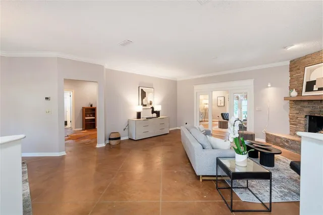 a work room with furniture a window and a ceiling fan