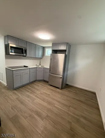 a kitchen with stainless steel appliances granite countertop a refrigerator sink and microwave